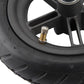 Pneumatic scooter rear wheel close-up of valve stem on black rubber tire