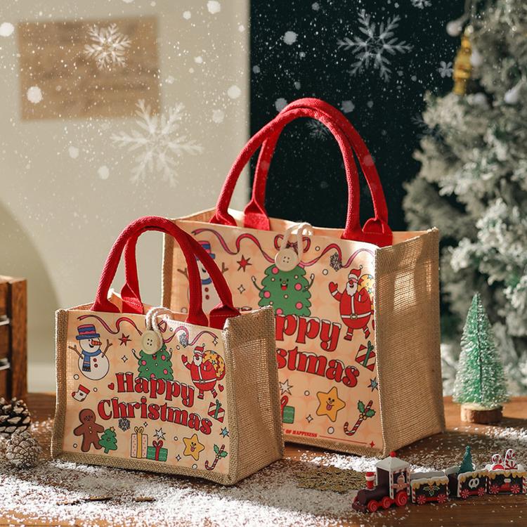 Two jute Christmas tote bags with red handles, “Happy Christmas” character artwork