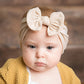 Infant hair bow headband with ivory bow on baby hair