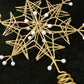 Gold glitter wire snowflake topper with faux pearl bead accents and coiled stem.