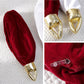 Red velvet inflatable Christmas ball ornament with gold loop cap, seam and valve detail