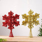 Glitter snowflake tree toppers in red and gold, each with spiral metal stem