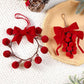 Red ribbon bow grape-cluster wreath ornament with fuzzy pom berries