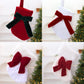Pair of hanging stockings: red with green plush bow and white with red bow