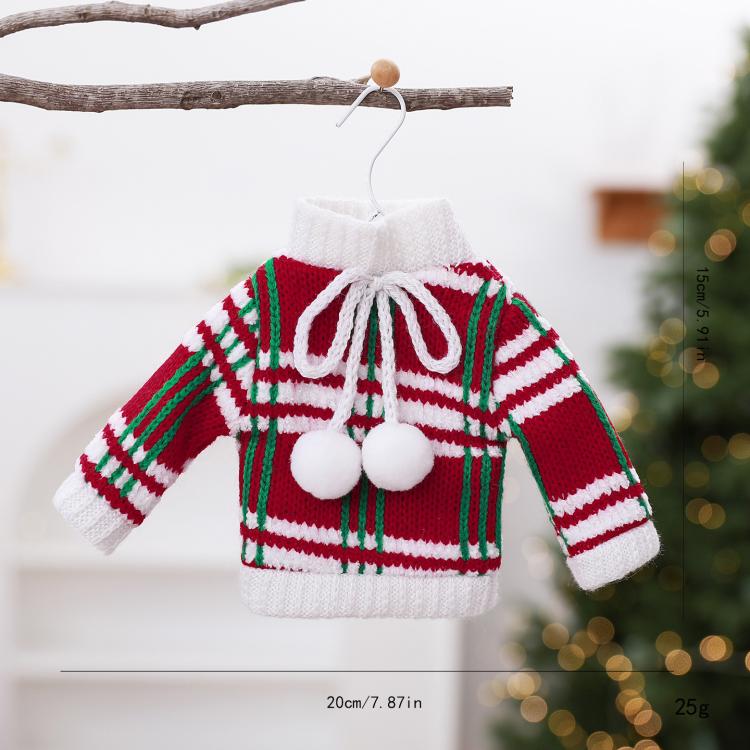 Mini knitted sweater ornament with red, green, and white stripes and pom pom accents.
