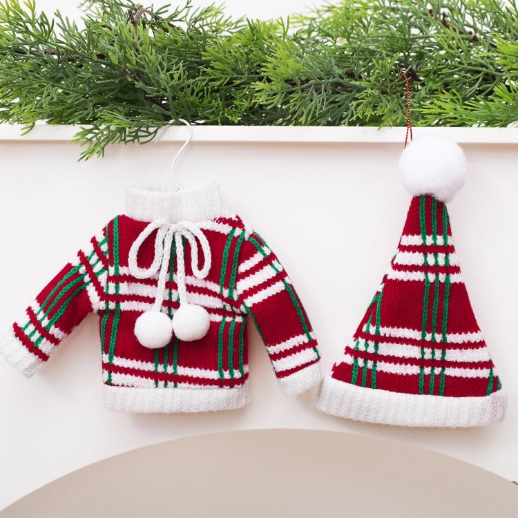 Mini knitted ornaments: green/white striped sweater and red striped hat with white trim.
