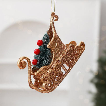 Gold glitter sleigh ornament with dark blue trees and red berry accents