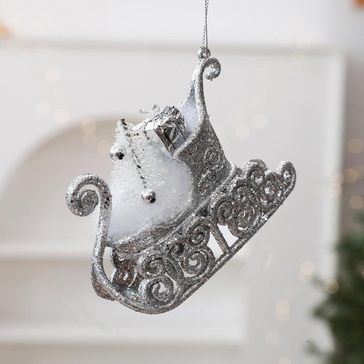 Silver glitter sleigh ornament with light blue accents and rhinestone-like bow