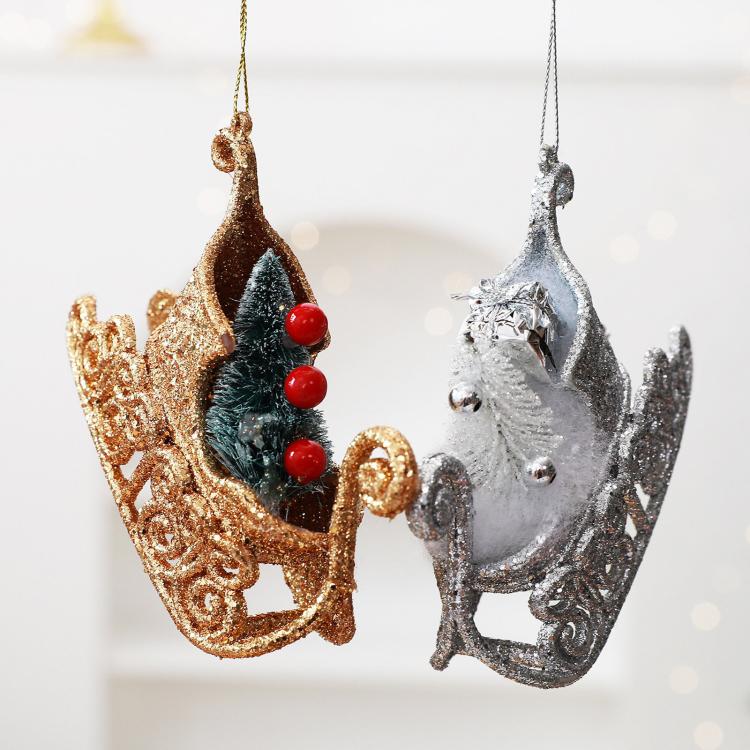 Gold and silver glitter sleigh ornaments with pine-tree motifs and red bead berries