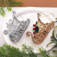 Two glitter sleigh ornaments on a plate: silver with beads and gold with pine accents