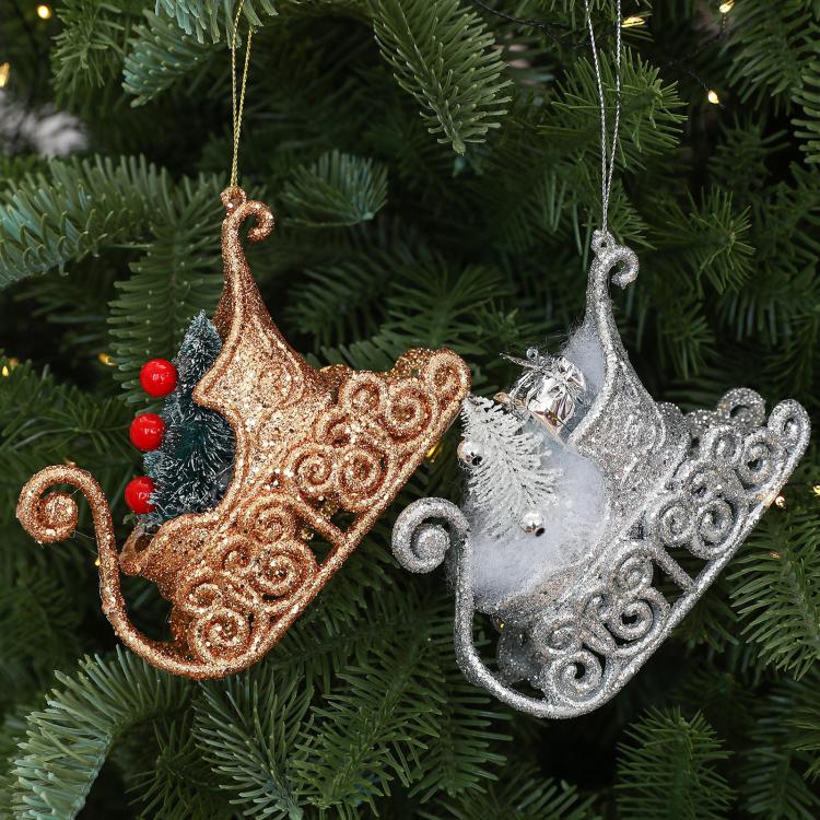 Hanging glitter sleigh ornaments: gold and silver designs with pine and red berry details