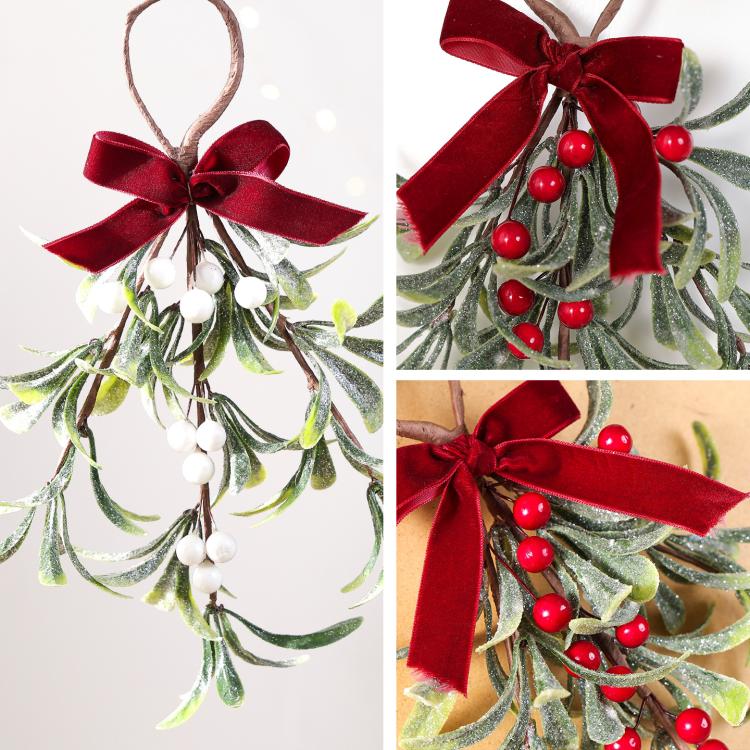 Mistletoe hanging ornament detail view with red velvet bow, red berries and white berry accents