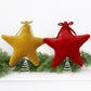 Gold and red plush velvet star tree toppers with bows and spiral spring bases