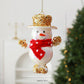 White snowman ornament with gold glitter top hat, red scarf, and hanging loop