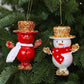 Hanging pair of snowman ornaments: red with white scarf, white with red scarf