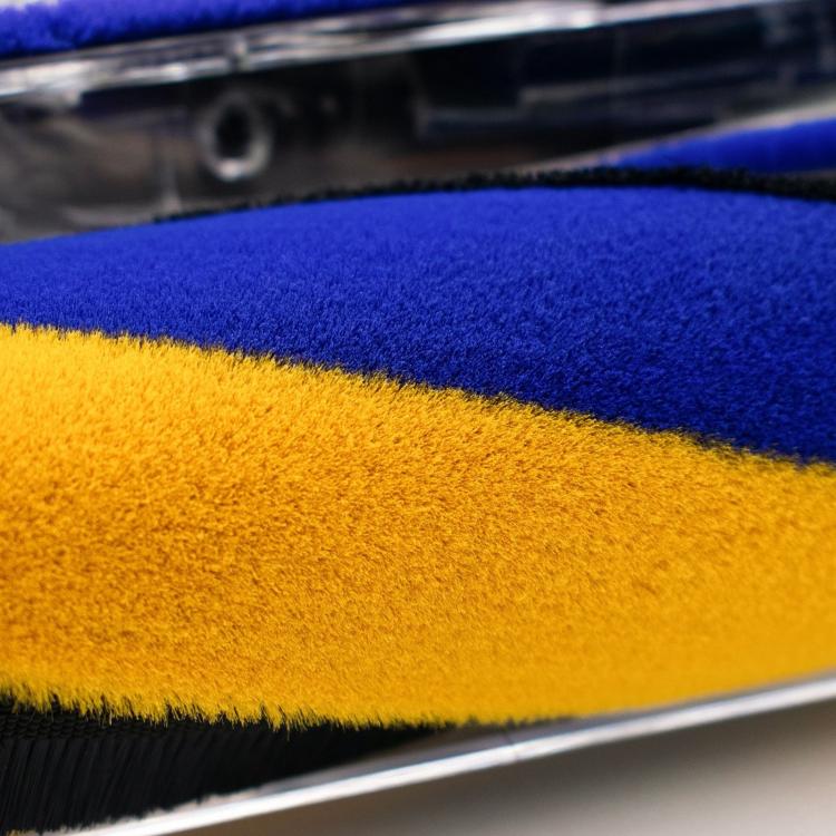 Close-up of blue and yellow fluffy brush roller inside clear head cover