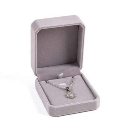 Gray octagonal velvet jewelry box, open with pendant necklace on inner tray