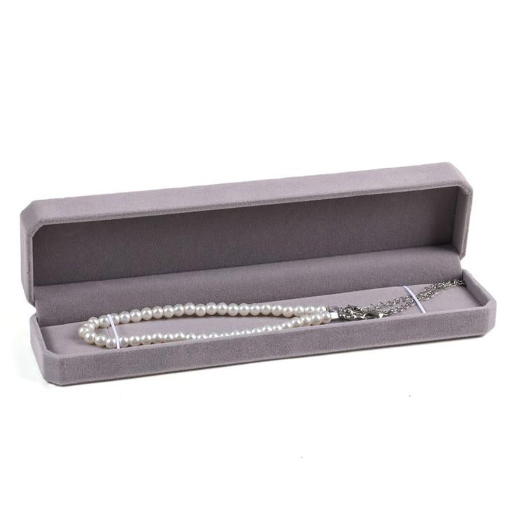Gray octagonal velvet jewelry box, open with long pearl necklace on padded tray