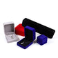 Octagonal velvet jewelry boxes in red, black, blue, and gray with necklace on display