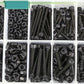 Assorted black socket head cap screws and hex nuts in compartmented plastic tray