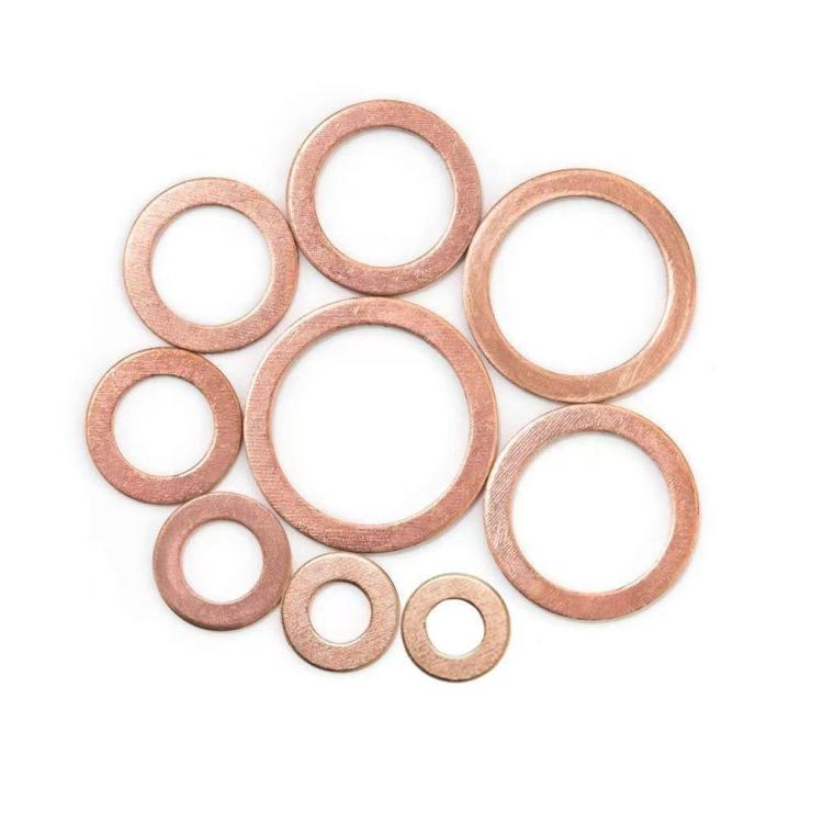 Solid copper flat sealing washers assortment, round copper washers laid out