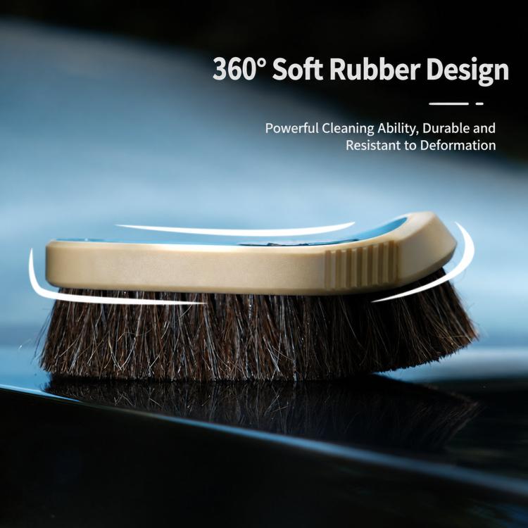 Horsehair cleaning brush with beige bristle head and soft rubber grip, close-up