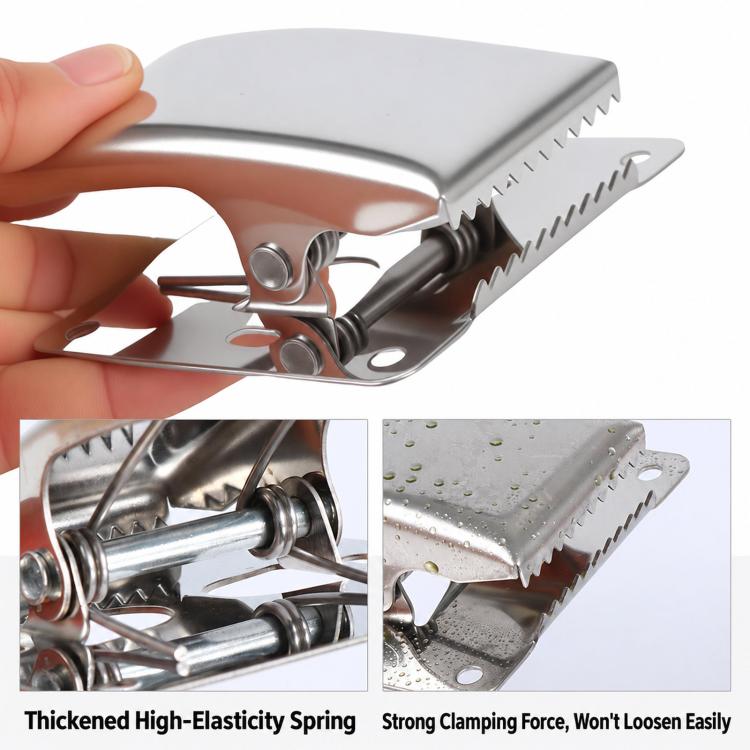 Stainless steel fish fillet clamp with serrated jaws and spring mechanism, shown in use