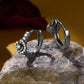 Pair of black hoop earrings with small round zircon stones around a floral cross motif