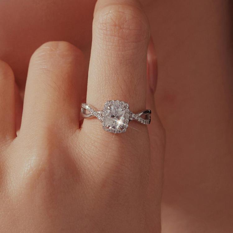 Sterling silver moissanite ring with oval center stone on a finger