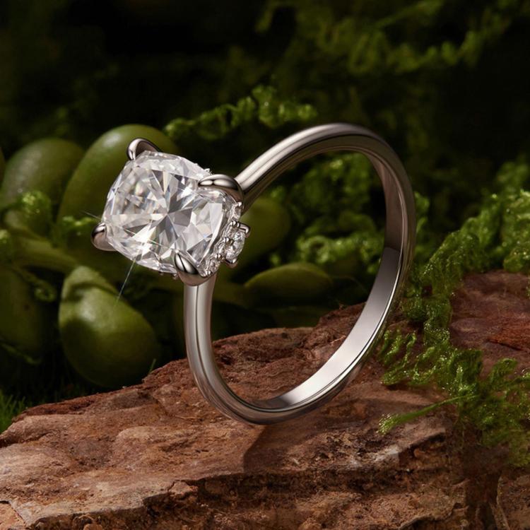 Close view of sterling silver ring showing four-prong square moissanite center