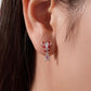 Sterling silver candy-cane heart stud earrings with dangling gingerbread charm on wearer
