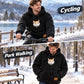 Black fleece pet hoodie on cyclist, cat peeking from front opening