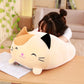 Cream cat plush cushion pillow with closed eyes and black ear patch detail