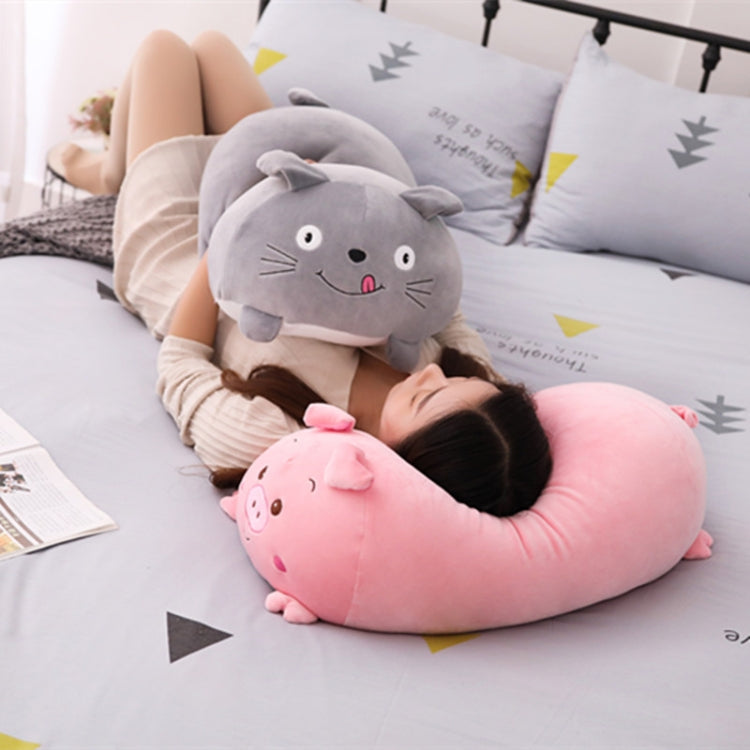 Gray cat plush cushion pillow with whiskers and pink tongue, being hugged on a bed