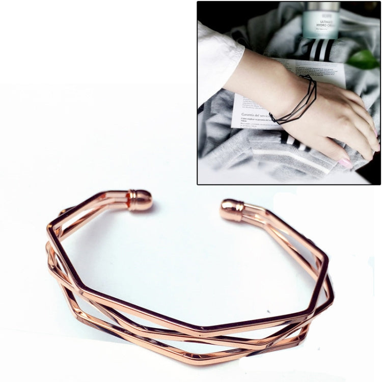 Rose gold multi-layer open cuff charm bracelet with angular lattice links.