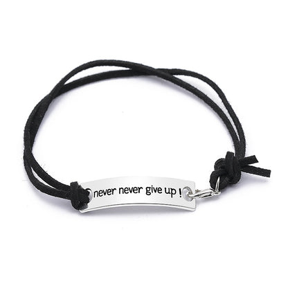 Black cord bracelet with silver bar clasp and “never never give up!” lettering