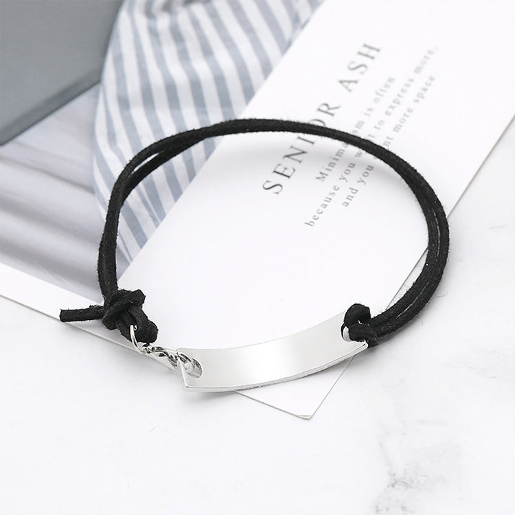 Black cord bracelet with silver bar clasp featuring “never” lettering