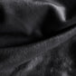 Black plush sofa cover fabric close-up, soft thick pile with visible nap texture