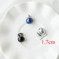 Assorted pearl collar pins with blue, silver, and black beads on display plate