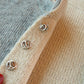Pearl stud collar pins on knit fabric with three silver-toned studs