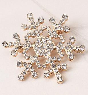 Gold-tone rhinestone snowflake brooch with sparkling crystal-like stones