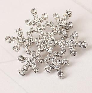 Silver-tone rhinestone snowflake brooch with detailed starburst crystal pattern