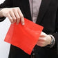 Rubber thumb tip on hand holding a red cloth stage prop