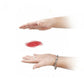 Magic trick prop shown in hands with a small red spinning disc
