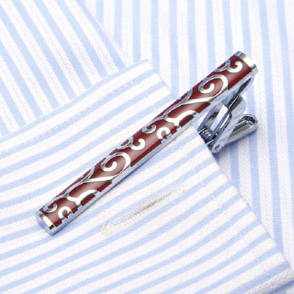 Enamel tie clip with red bar and swirling white pattern, silver metal clasp