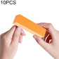 Orange nail sanding/buffing block foam rectangle, held for manicure