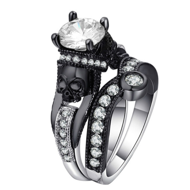 Triple-band skull ring with round clear center gemstone, black enamel details, silver stones