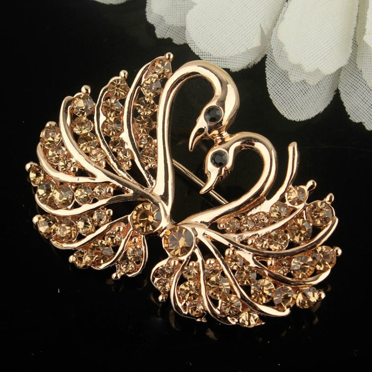 Gold-tone rhinestone swan brooch, detailed crystal wings and heart-like base