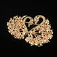 Gold-tone crystal swan brooch showing side profile and pin back hardware