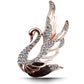 Rose-gold tone swan crystal brooch with clear stones and a dark central gem